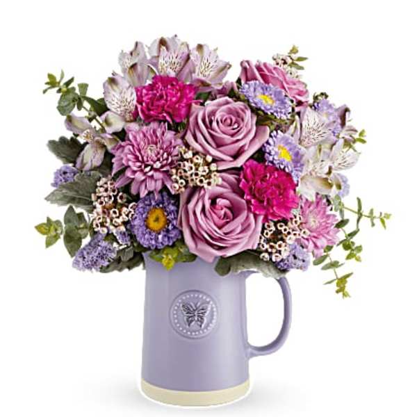 Lavender and pink bouquet in a purple pitcher vase