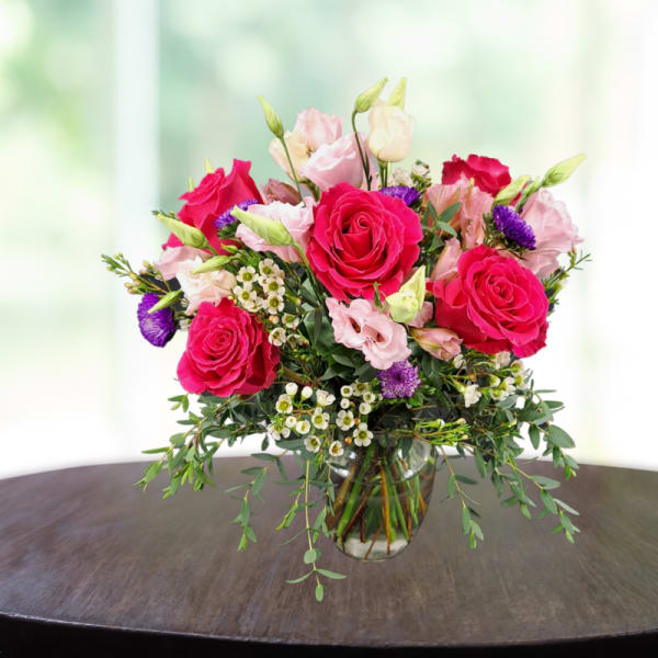 Bouquet of pink and red roses in a clear glass vase