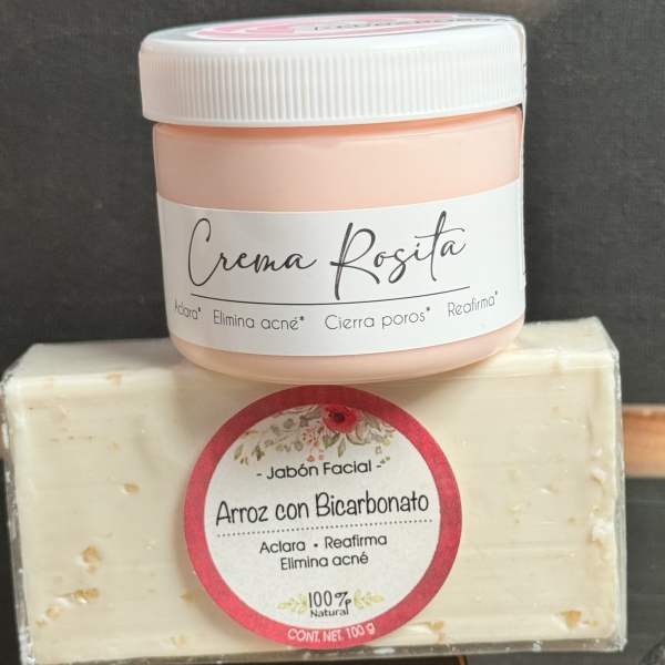 A pink cream jar sits on top of a wrapped facial soap bar.