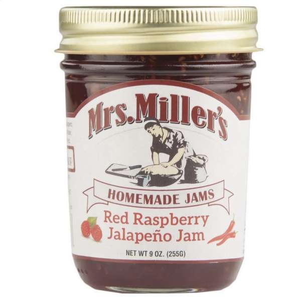 Jar of red raspberry jalapeño jam with a gold lid