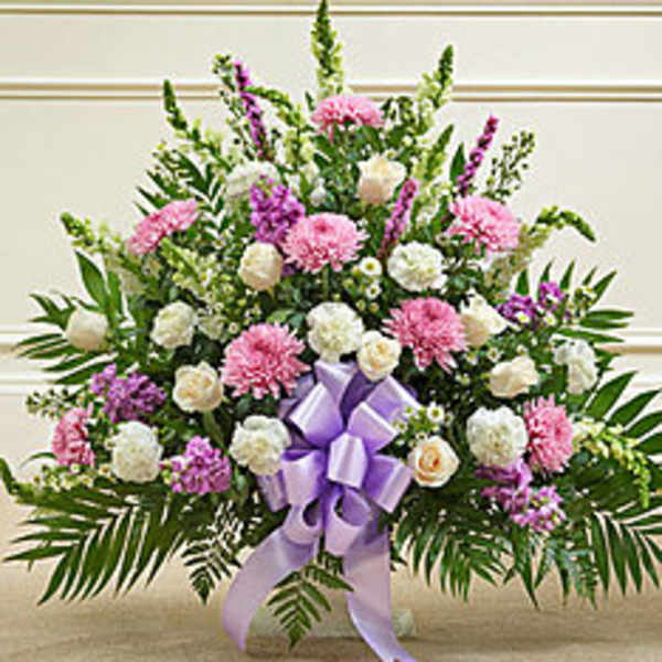 Large pink and white floral spray with a lavender ribbon bow