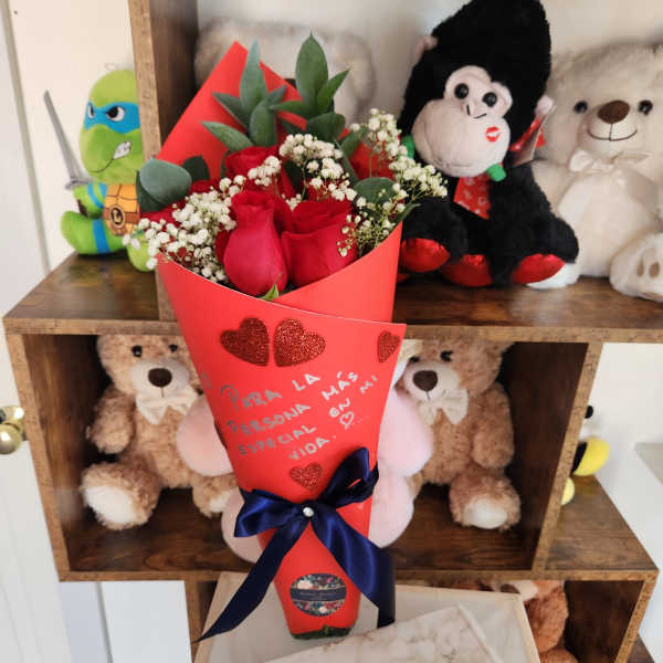 Red rose bouquet with baby's breath in red wrapping and a navy ribbon