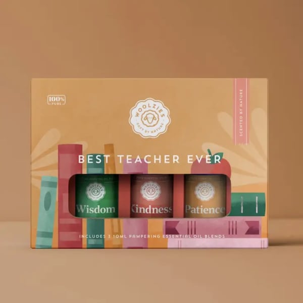 Teacher-themed gift box holding three essential oil bottles labeled Wisdom, Kindness, and Patience
