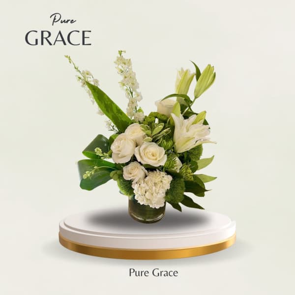 White roses and lilies arranged in a glass vase