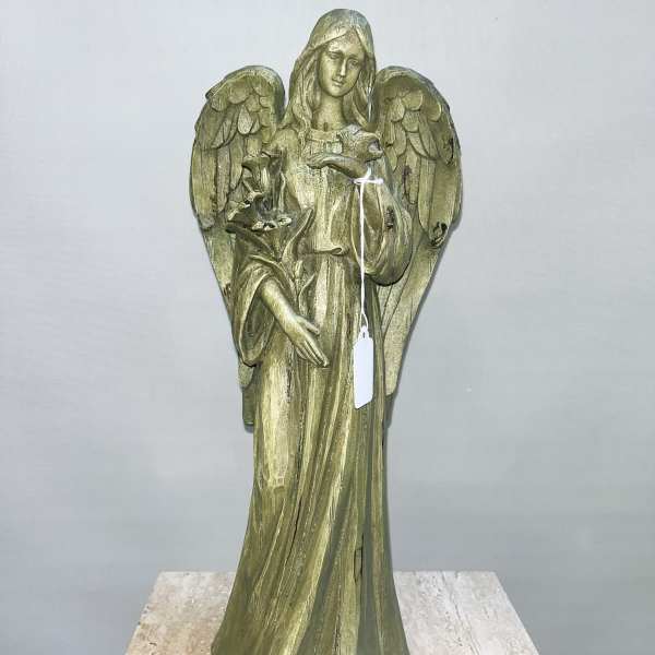Angel statue holding a bird and flowers