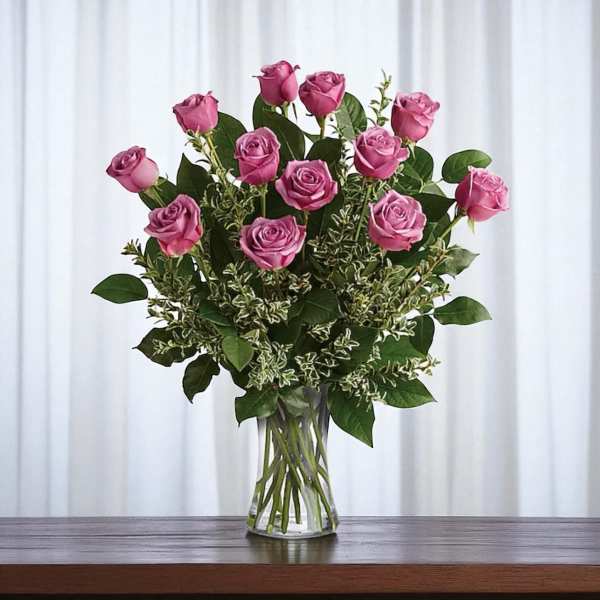 Pink roses arranged in a clear glass vase