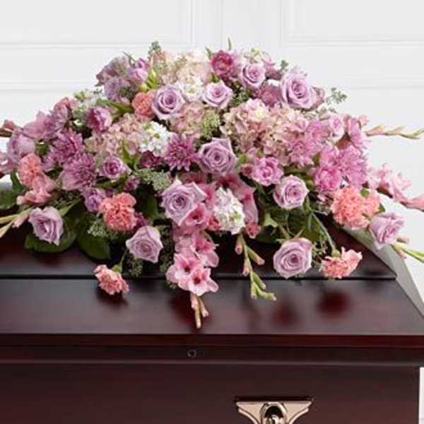 Large pink and lavender floral casket spray with roses and carnations