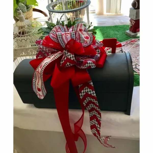 Black chest with a large red and patterned ribbon bow