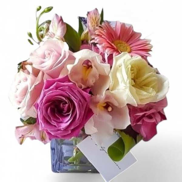 Pink and white mixed bouquet in a blue glass vase