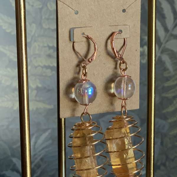 Pair of dangling crystal earrings with copper wire coils