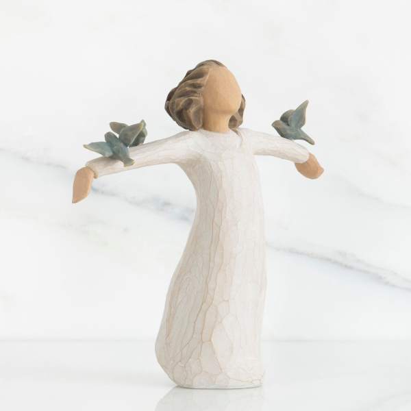 Wooden angel figurine with outstretched arms and blue birds on each shoulder