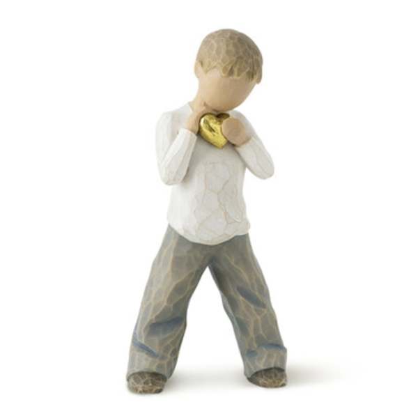 Small figurine holding a gold heart against its chest