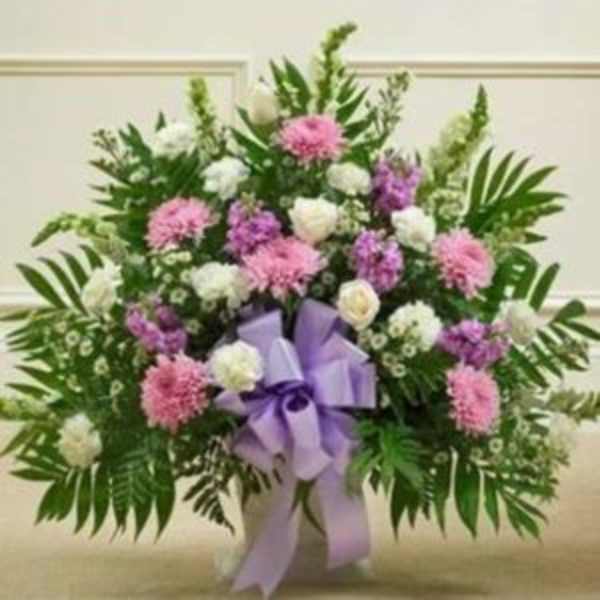 Pink and white floral spray with a lavender ribbon bow