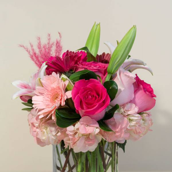 Pink mixed bouquet in a clear square glass vase