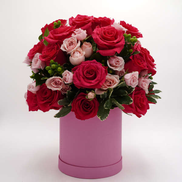 Bouquet of red and pale pink roses in a pink box