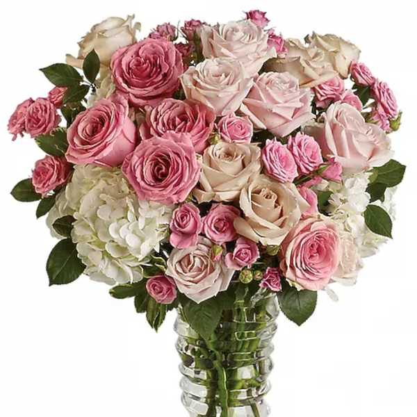 Pink and cream rose bouquet in a clear glass vase