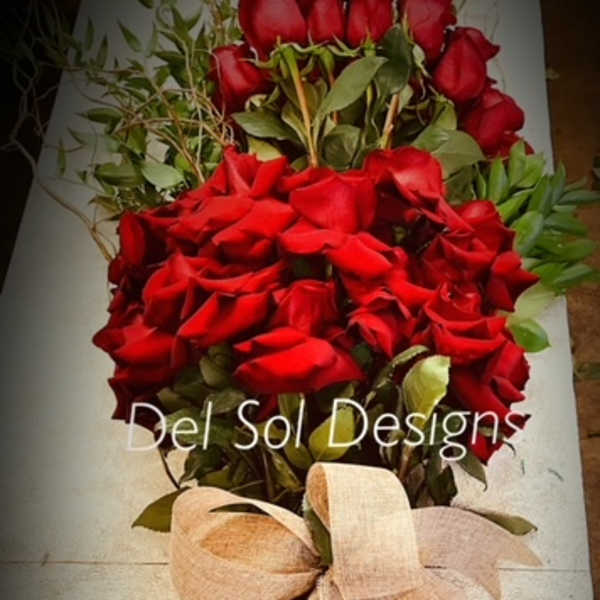 Bouquet of red roses with a beige ribbon wrap