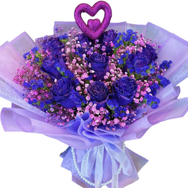 Purple rose bouquet with pink filler flowers and a heart topper