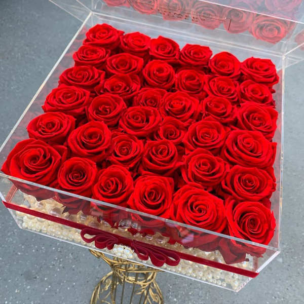 Box of red roses in a clear acrylic container