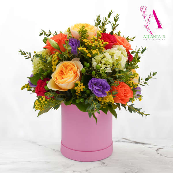 Mixed bouquet of roses and lisianthus in a pink hatbox