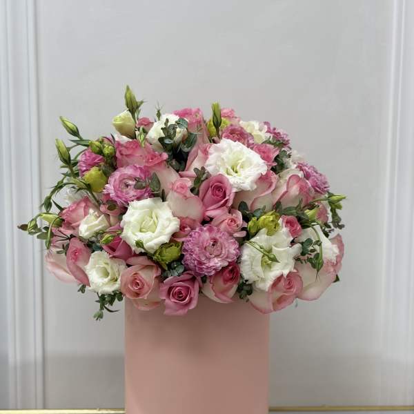 Pink and white flower arrangement in a tall blush box