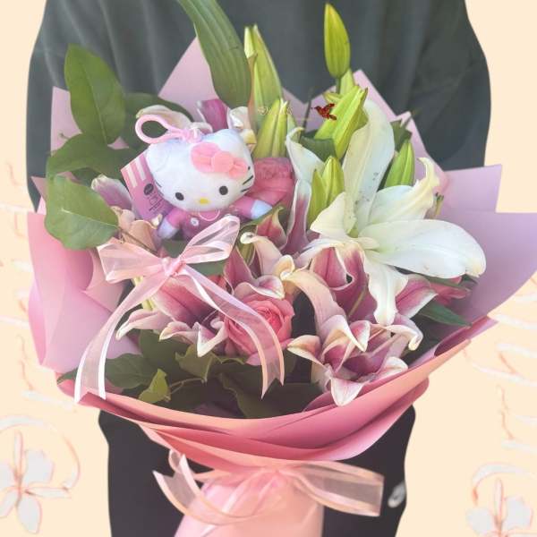 Pink and white lily bouquet with a Hello Kitty plush and ribbon wrap