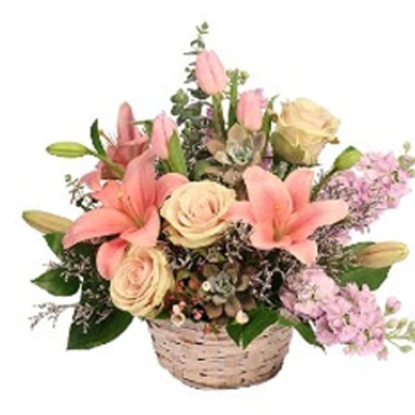 Basket arrangement with pink lilies, cream roses, and lavender flowers
