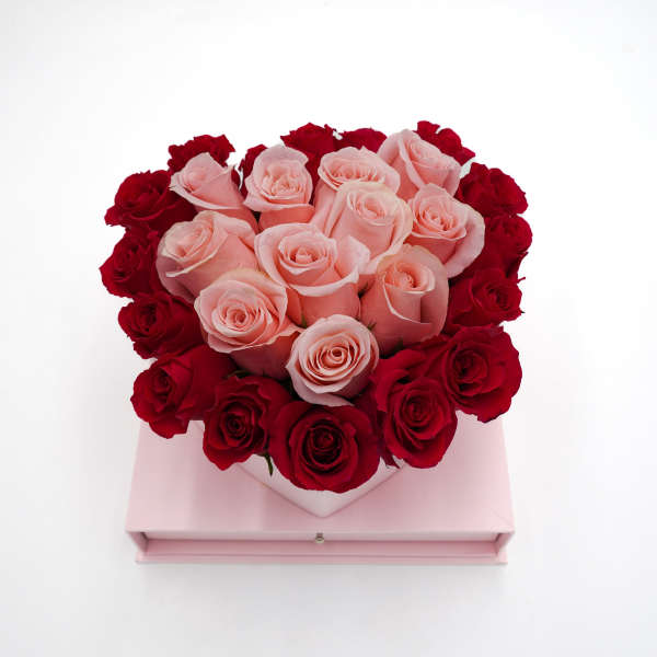 Heart-shaped box of pink and red roses