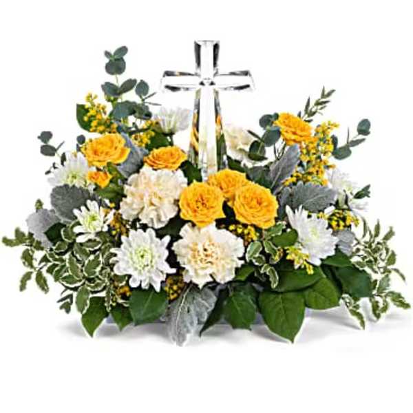 Yellow and white floral arrangement with a clear glass cross centerpiece