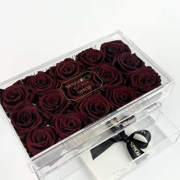 Box of deep red roses in a clear acrylic case