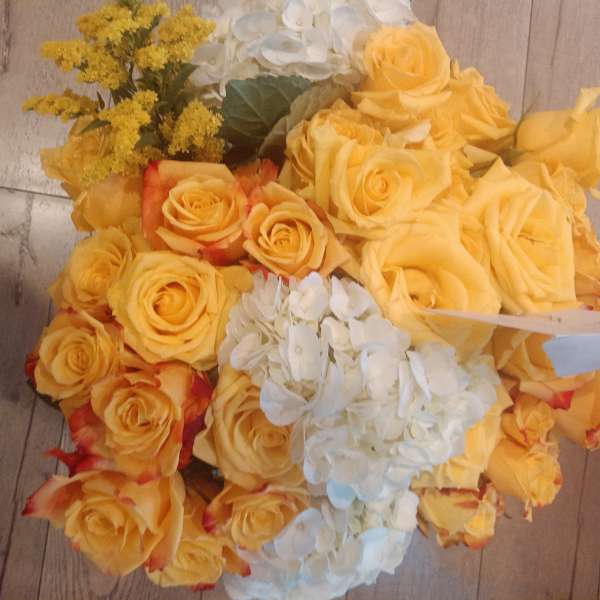 Bouquet of yellow roses with white hydrangeas and yellow filler flowers