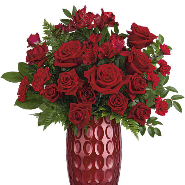 Red roses and red alstroemeria in a tall red vase