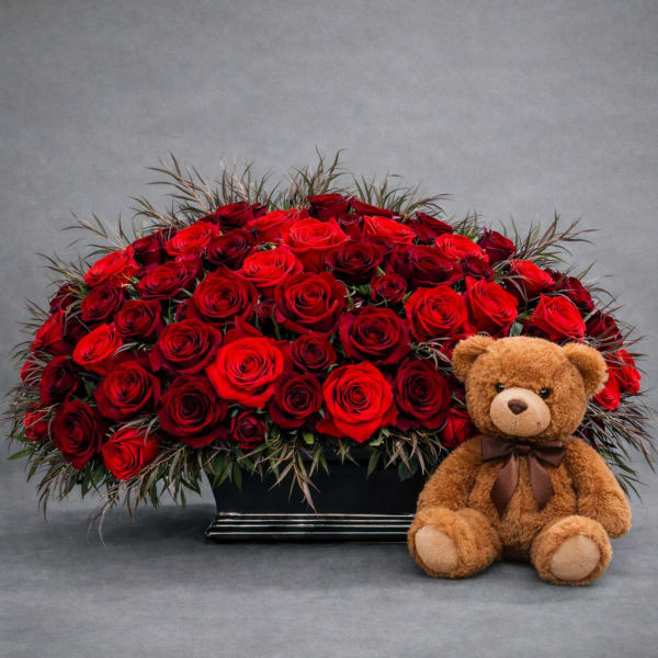 Red rose arrangement with a teddy bear