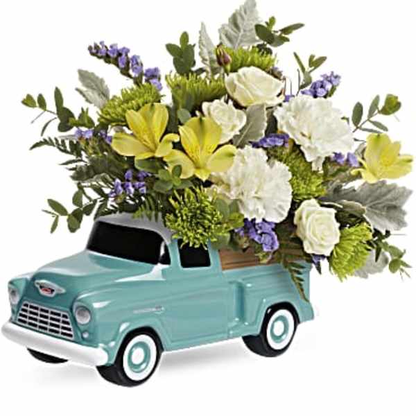 Floral arrangement in a turquoise vintage truck container