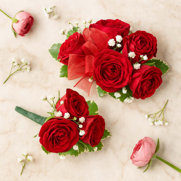 Two small red rose bouquets with baby’s breath on a light background