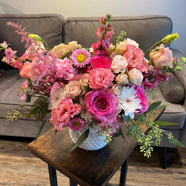 Pink and peach mixed bouquet in a white vase