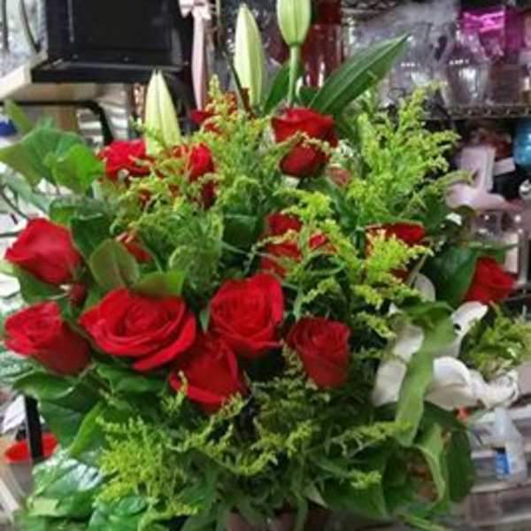 Red roses and white lilies arranged in a tall vase