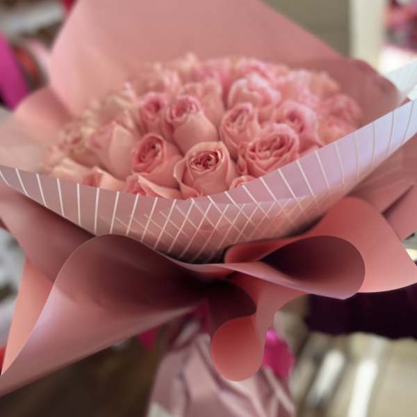 Bouquet of pink roses wrapped in pink paper