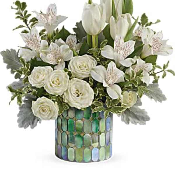 White tulips and roses in a mosaic glass vase