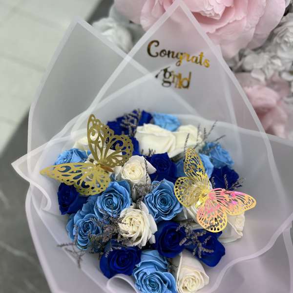 Bouquet of blue and white roses with butterfly picks