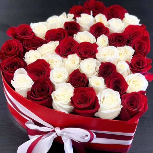 Heart-shaped box filled with red and white roses