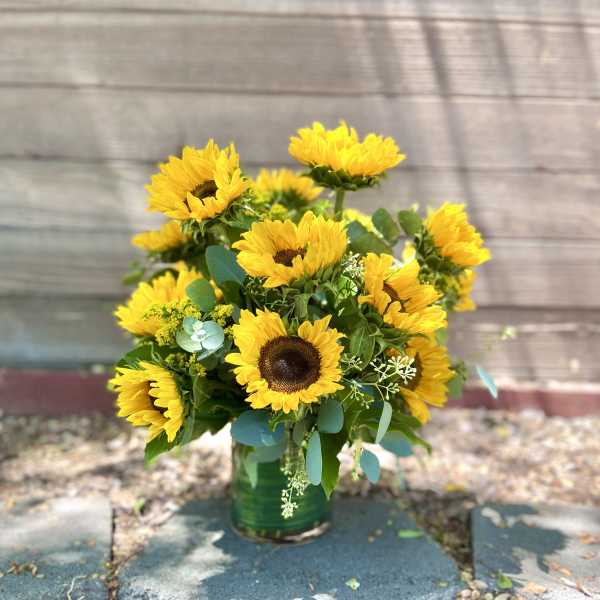 Bouquet of yellow sunflowers in a green vase