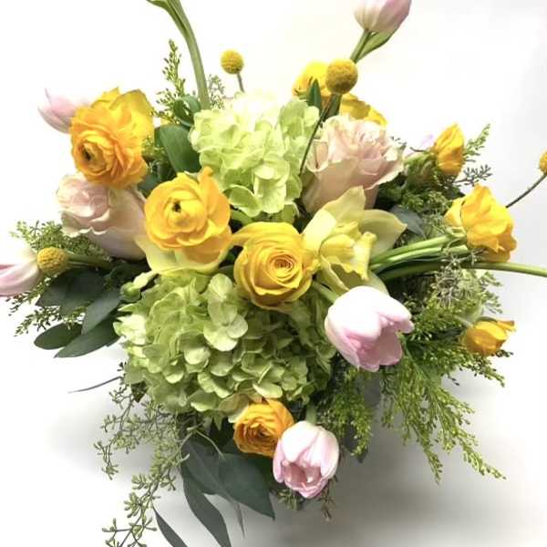 Bouquet of yellow and pink flowers with green hydrangea on a white background