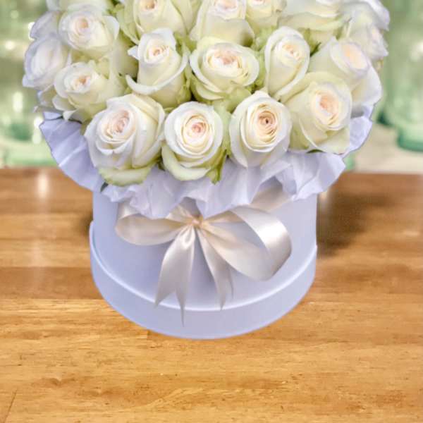 White rose bouquet in a round hat box with a satin ribbon