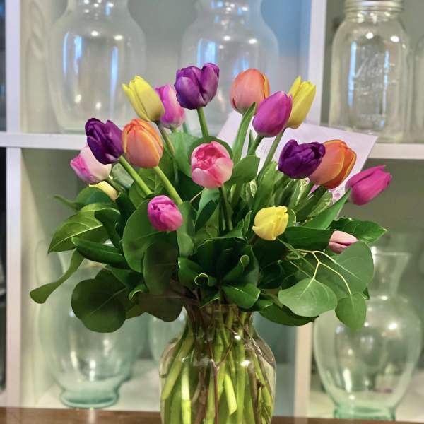 Colorful tulip bouquet in a clear glass vase