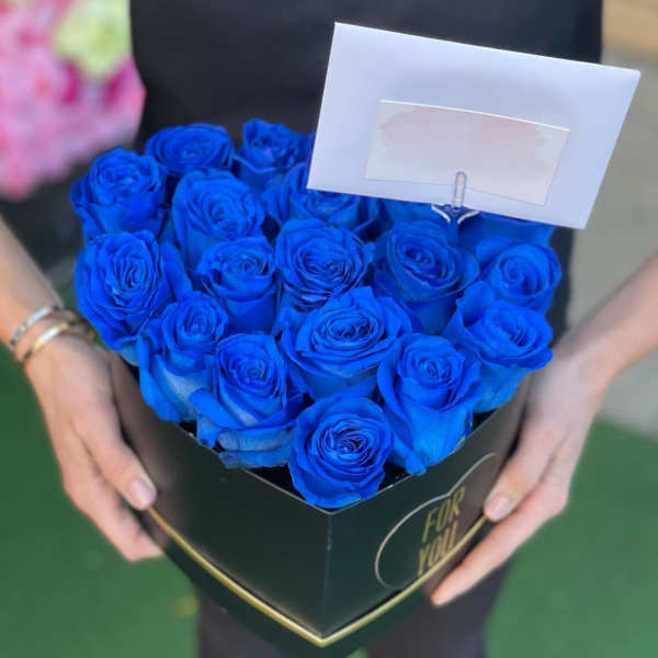 Box of vivid blue roses with a blank card holder