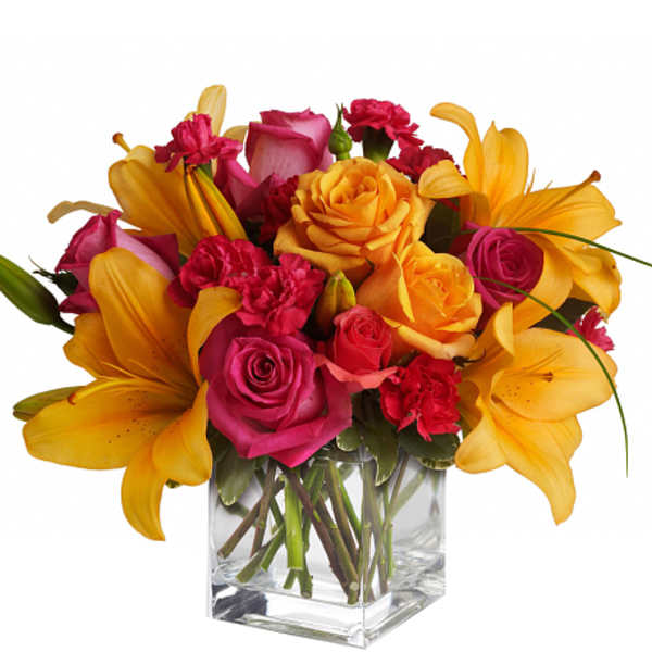 Bouquet of pink and yellow flowers in a clear glass vase