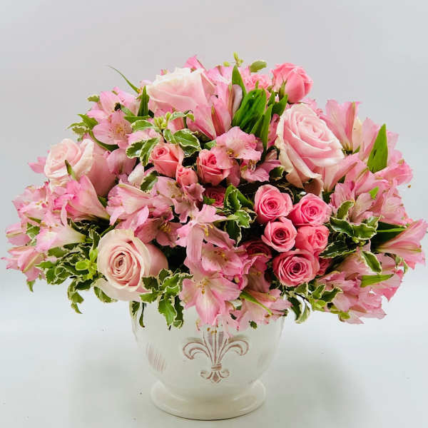 Pink roses and alstroemeria arranged in a white vase