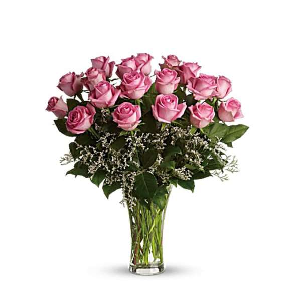 Pink roses arranged in a clear glass vase