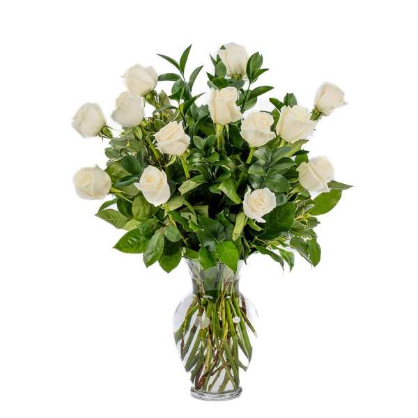 Tall arrangement of long-stem white roses in a clear glass vase